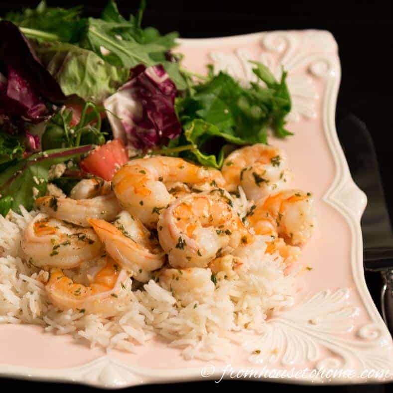 lemon butter garlic shrimp on a plate with salad