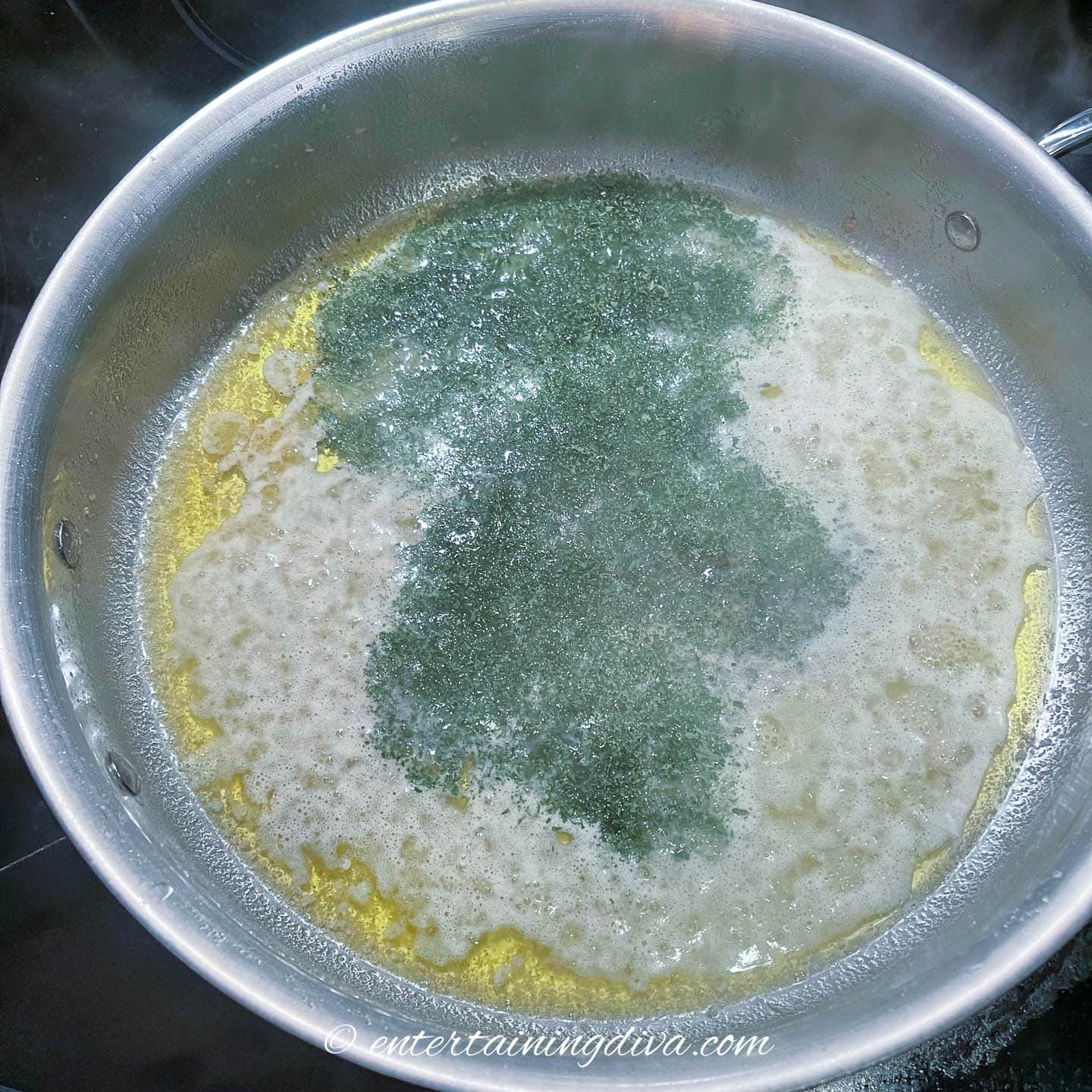 Seasonings and lemon garlic butter sauce in a frying pan