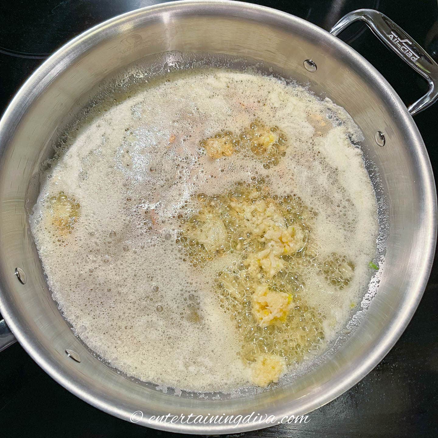 Garlic cooking in butter in a saucepan