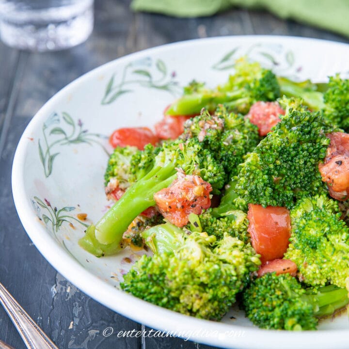 microwaved broccoli with tomatoes and spices in a serving bowl