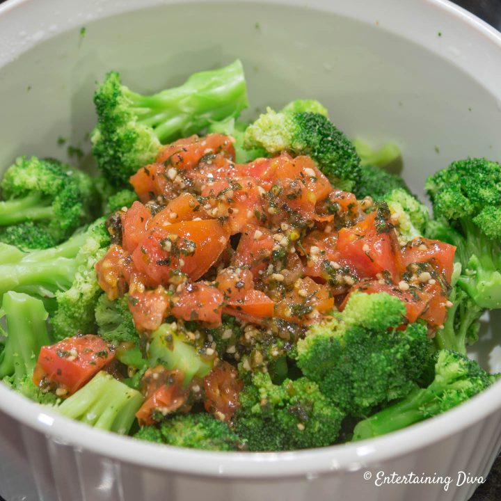 Tomato mixture on top of the broccoli in a corning ware dish