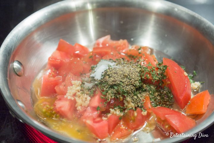 Tomatoes, garlic and spices in a small frying pan