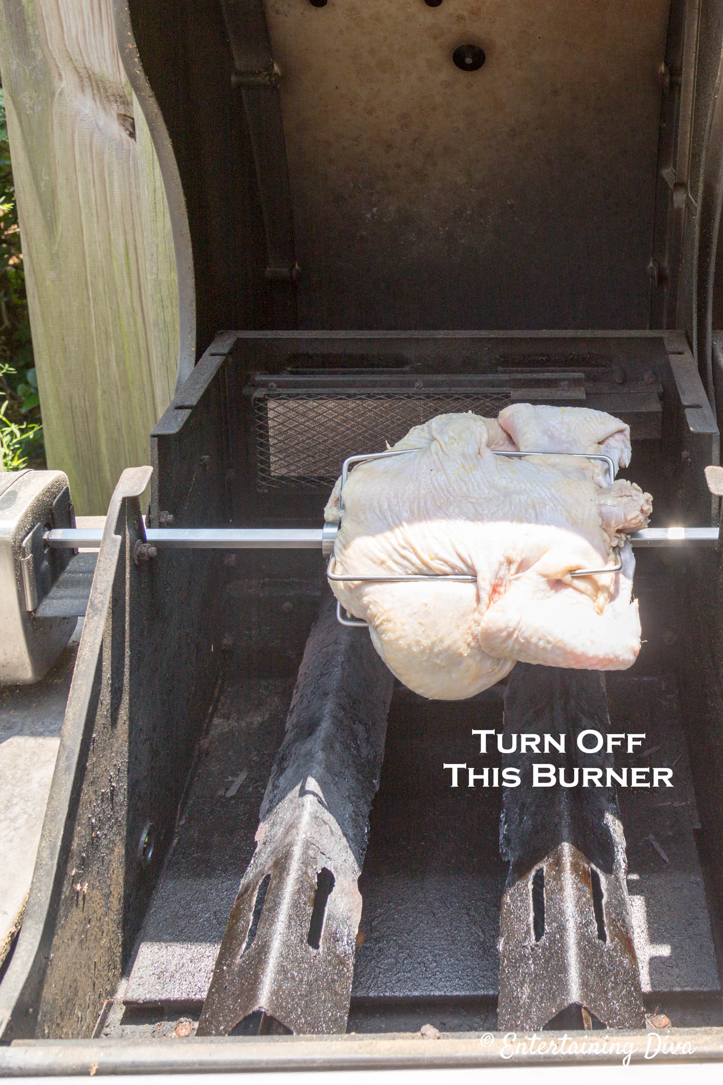 chicken on a rotisserie on a grill