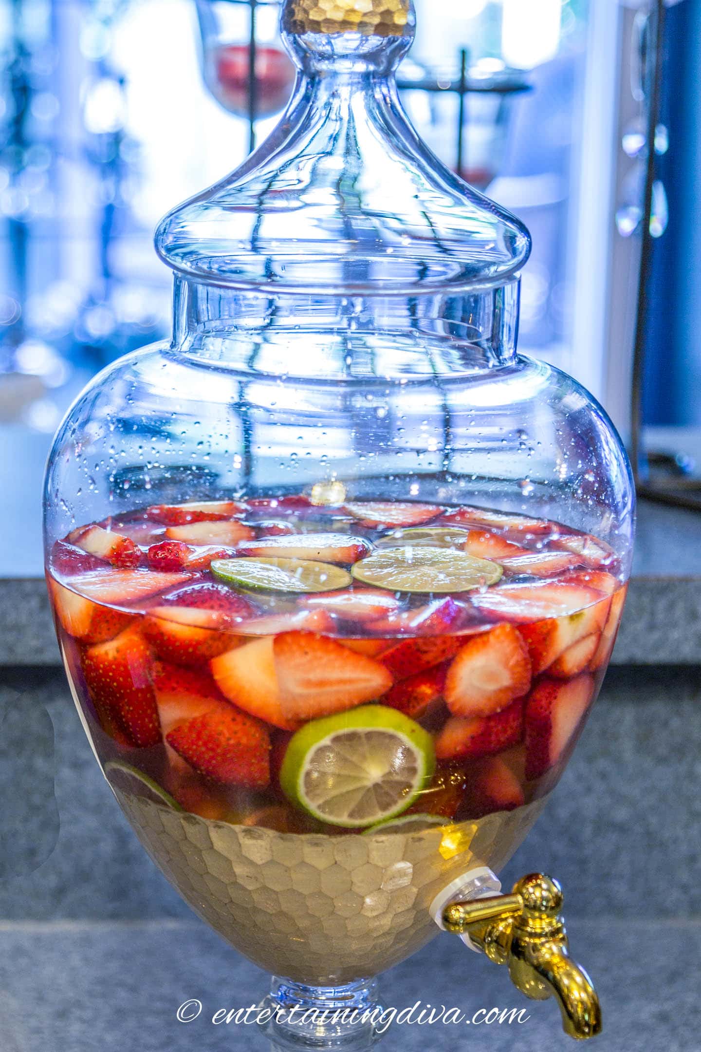 berries, limes and rose wine in a drink dispenser