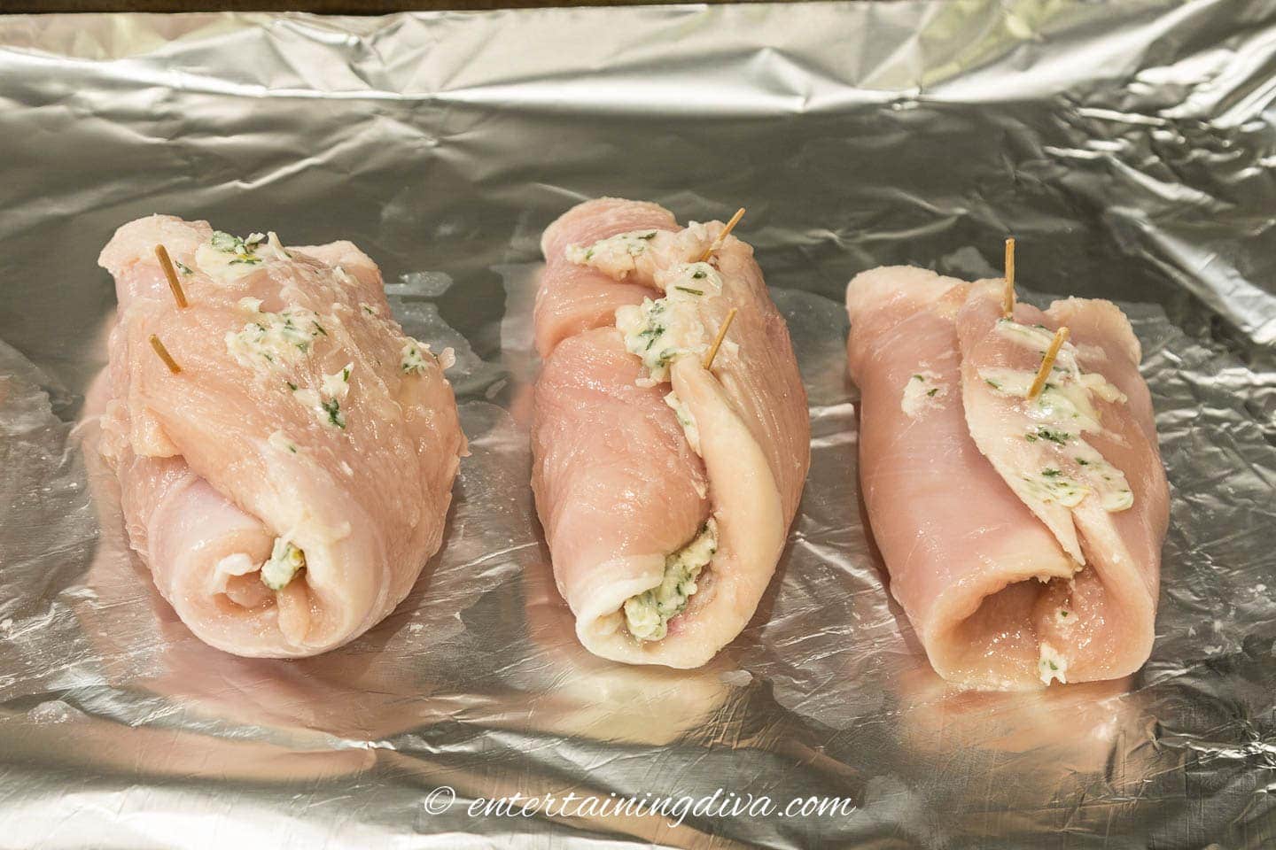 chicken roll ups on a baking sheet before baking