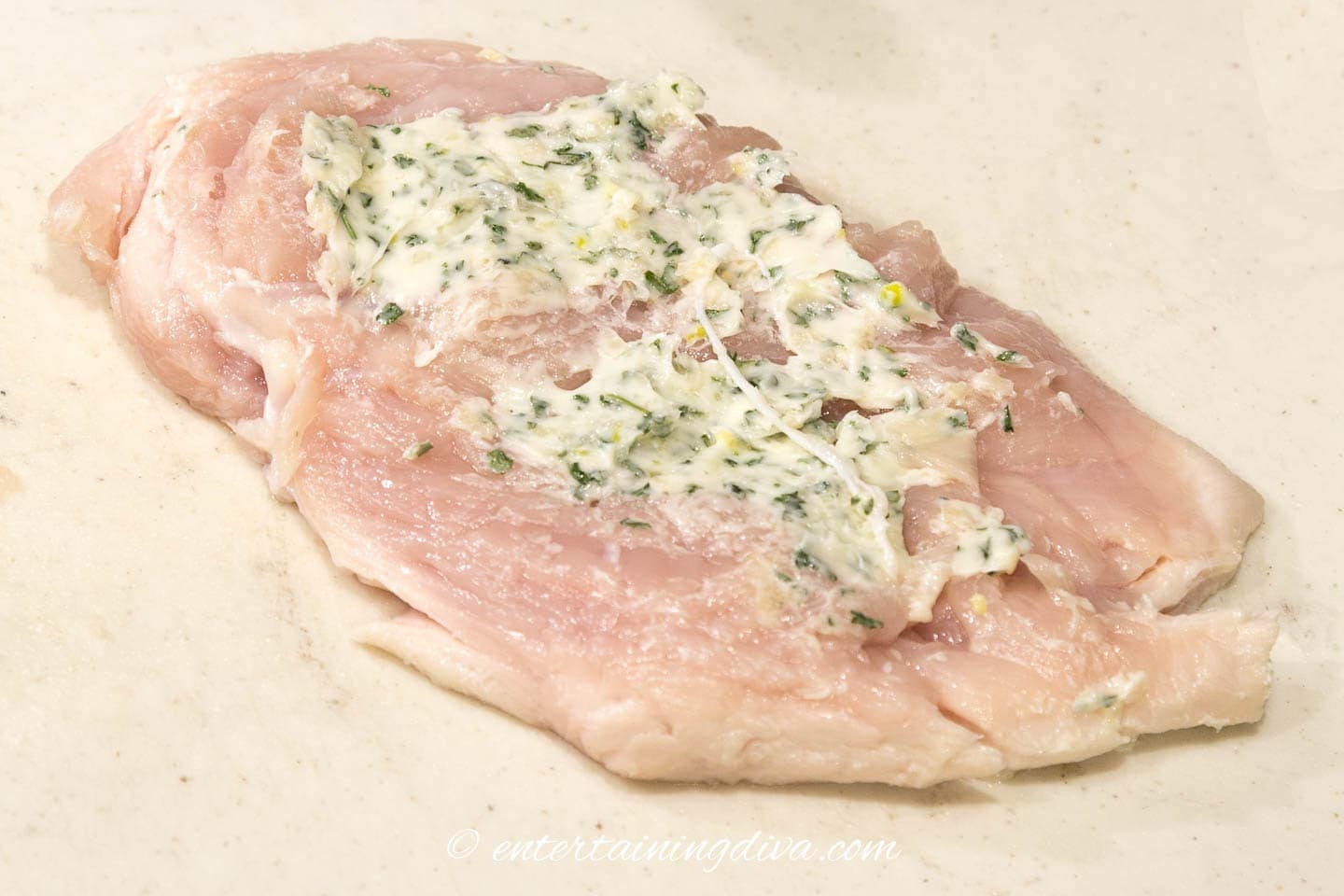 Garlic butter spread on a chicken breast