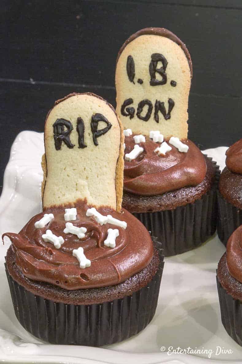 Halloween graveyard cupcakes with tombstone cookies and skeleton bones