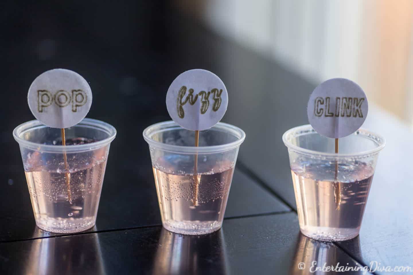 Pink champagne jelly shots with pop, fizz, clink toothpicks