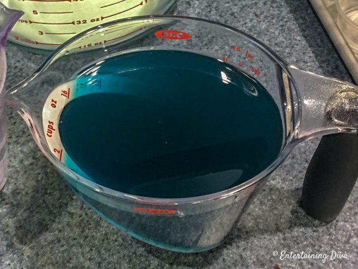 Tequila, Blue Curacao and Margarita mix in a measuring cup