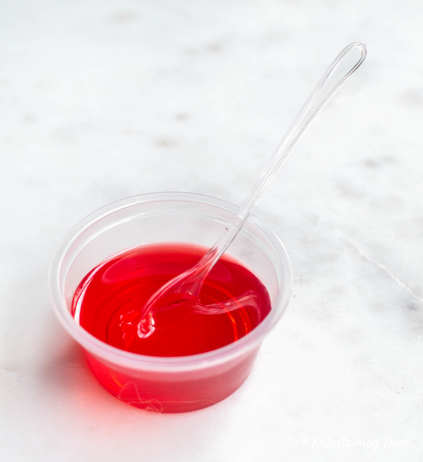 cherry fireball jello shots served with an appetizer spoon