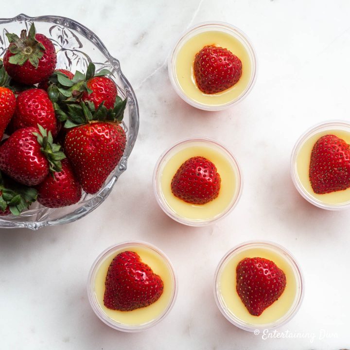 Strawberries and cream jello shots with strawberries on top