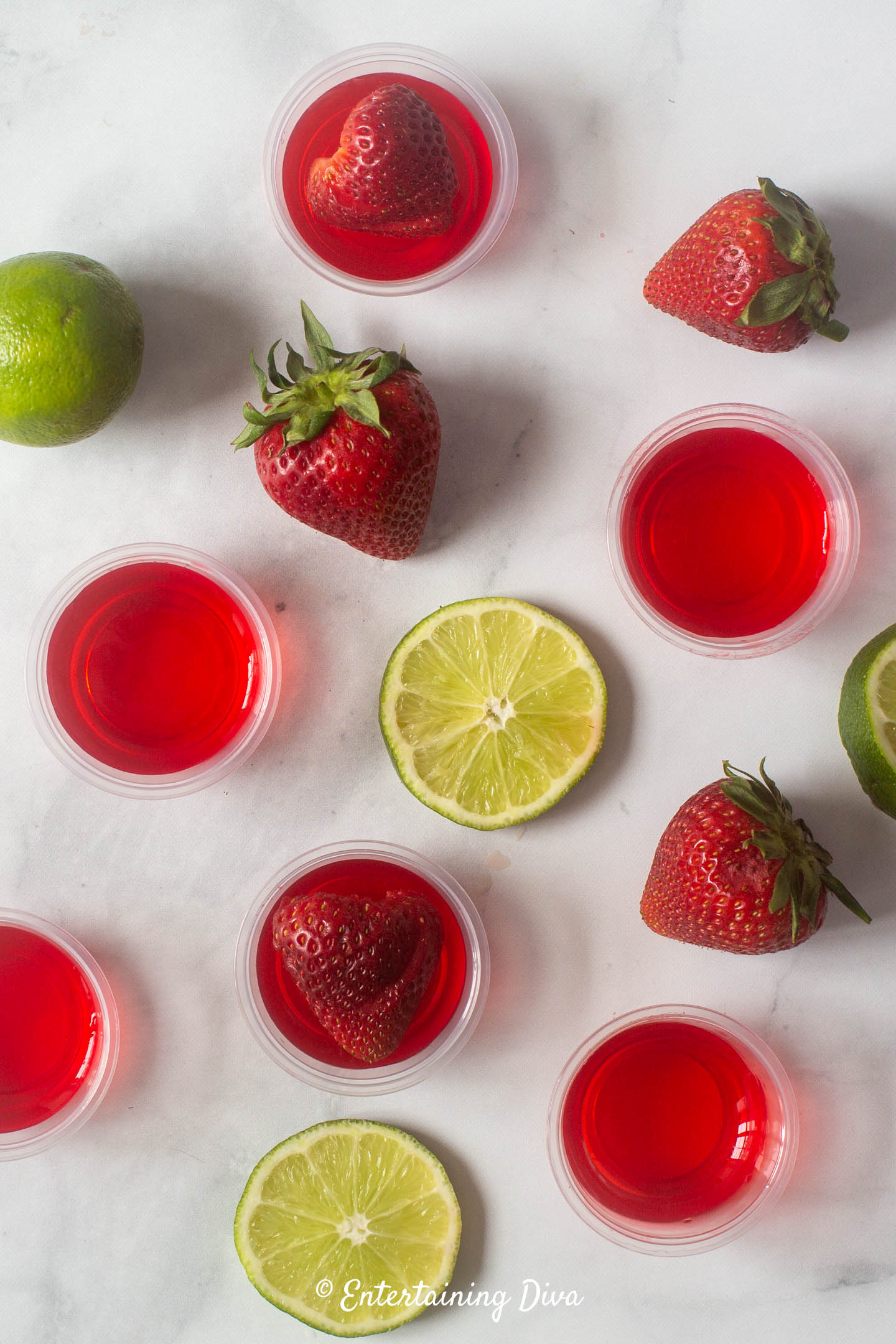 strawberry margarita jello shots with strawberries and limes