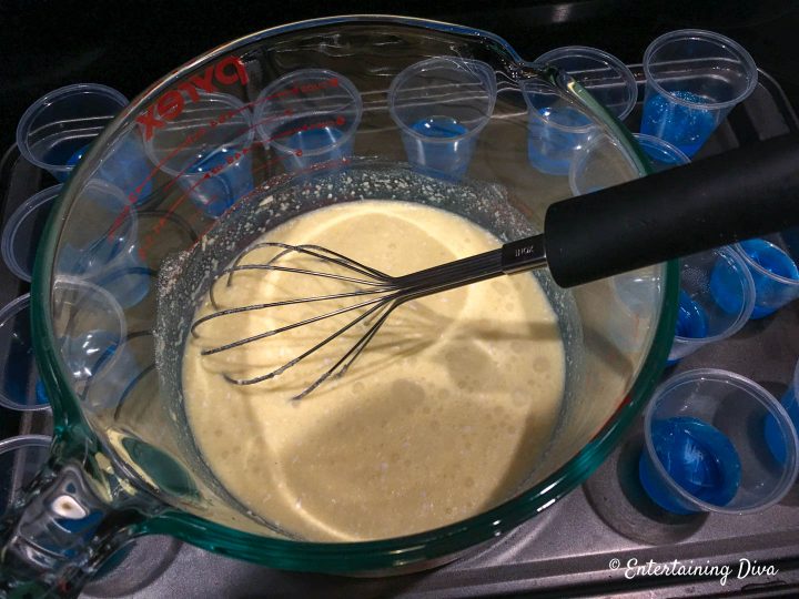 Coconut cream pudding layer being mixed with a whisk