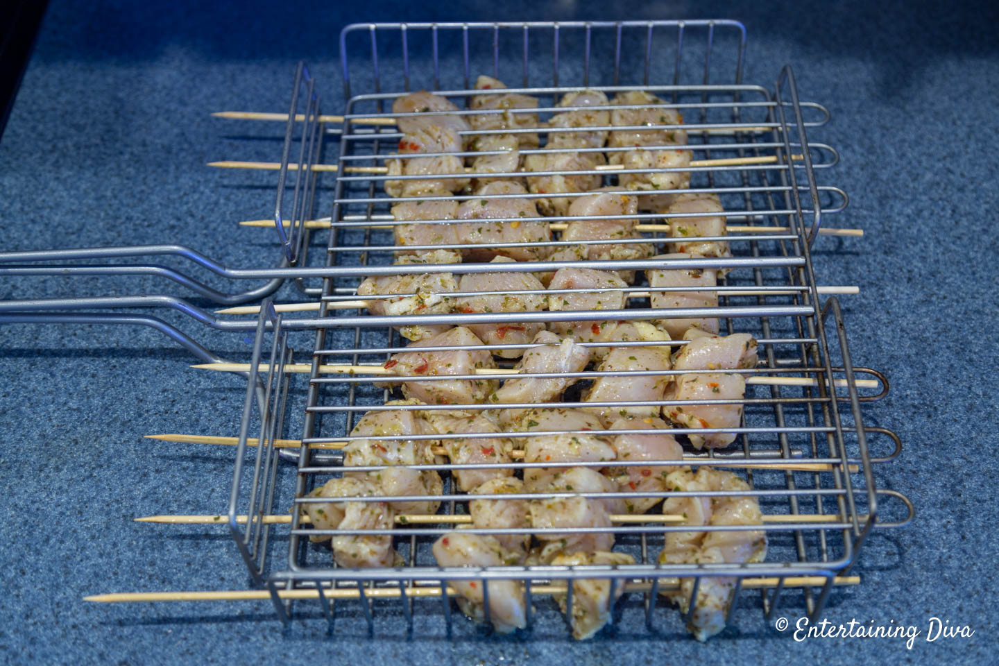Lemon chicken shish kabobs in a grilling basket
