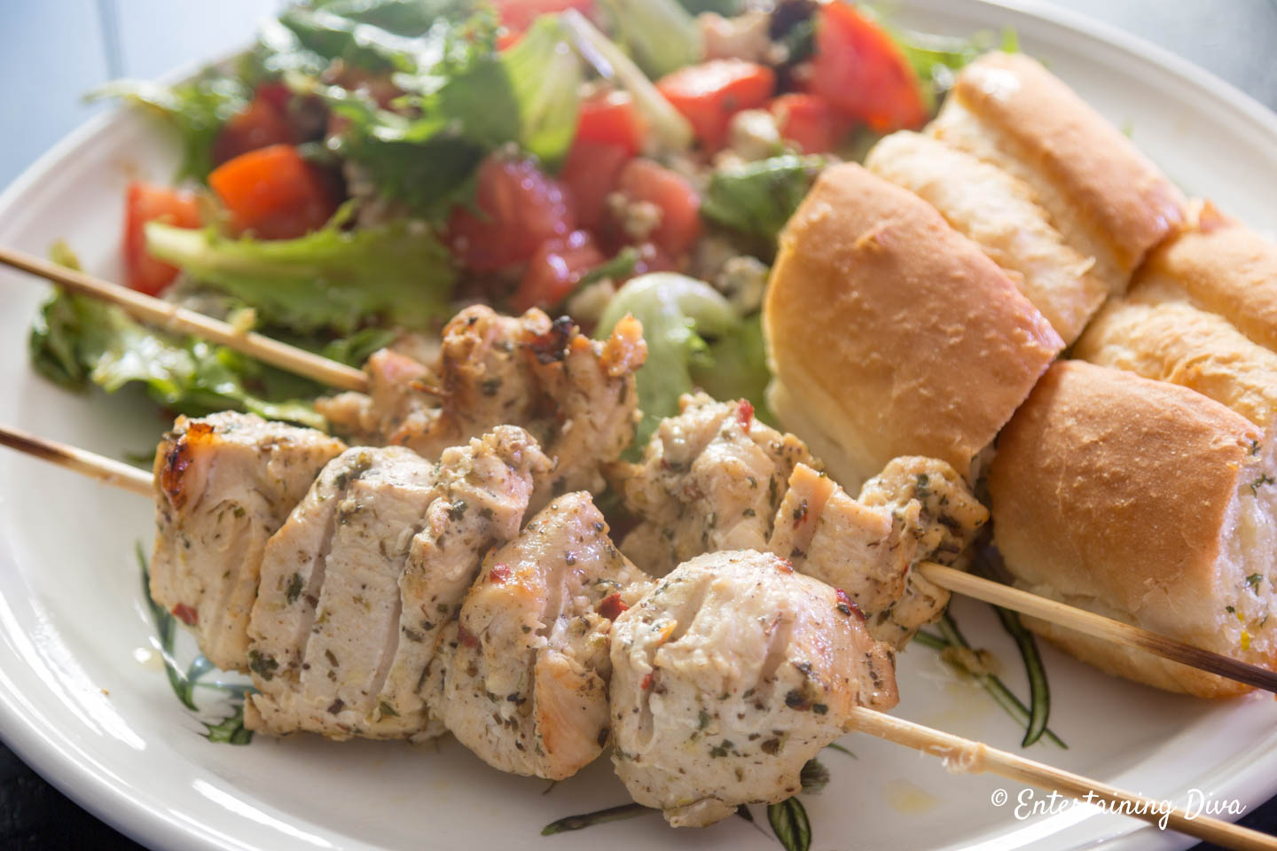 Chicken Shish Kabobs on a plate with salad