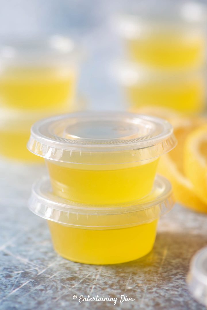 Lemon drop jello shots in a jello shot cup with a lid