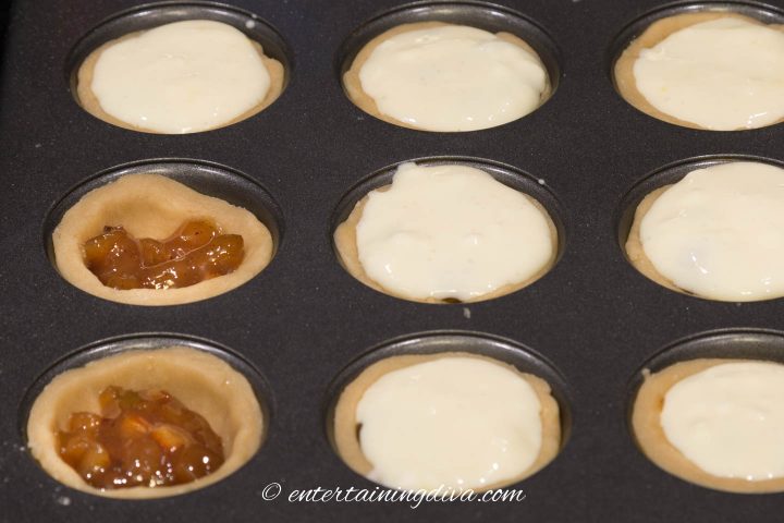 Tart shells filled with mincemeat and topped with cheesecake