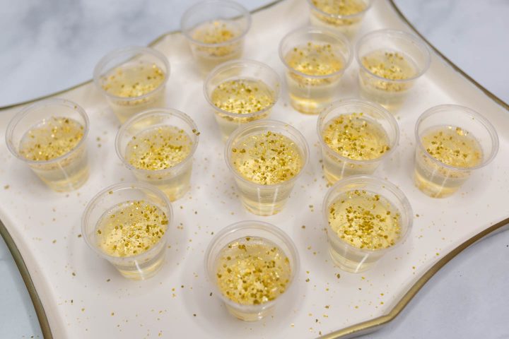 gold champagne jello shots on a tray