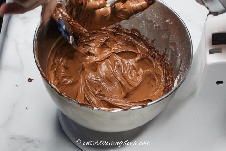 Butter mixed with melted chocolate in a mixing bowl