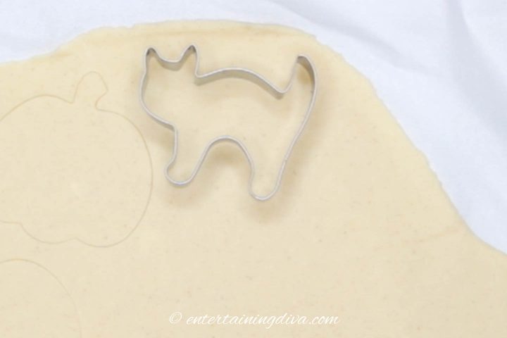cat cookie cutter on sugar cookie dough