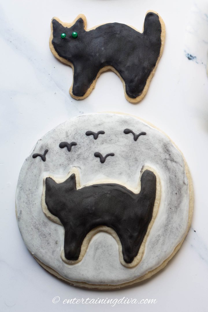 black sugar cookie and a black cat silhouette in front of the moon cookie