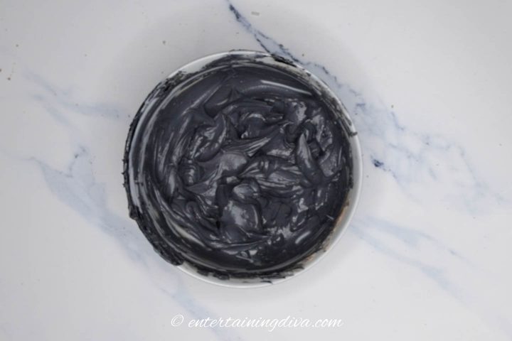 black royal icing in a bowl