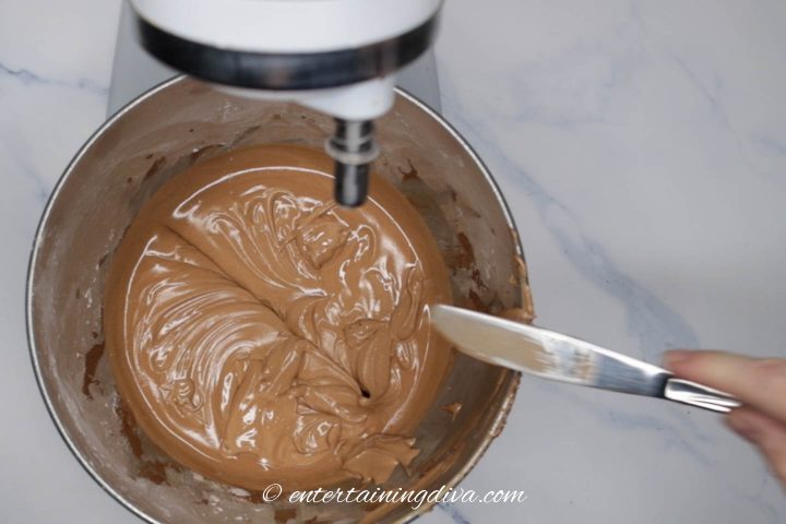royal icing with cocoa powder in a mixing bowl after being tested for consistency