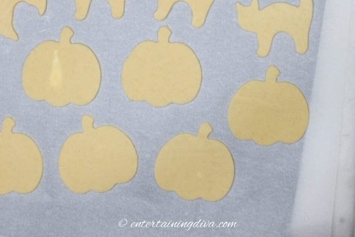 Pumpkin cut outs on a cookie sheet