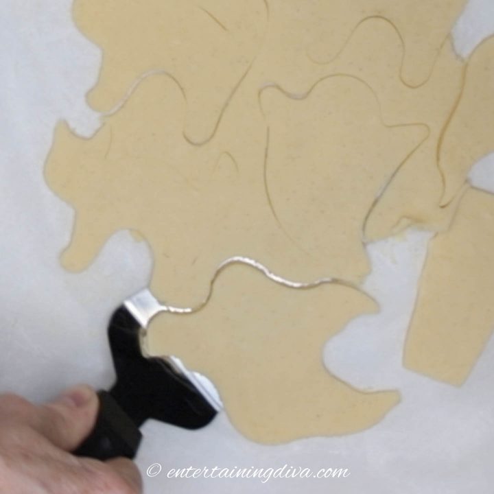 spatula removing ghost cookie from parchment paper