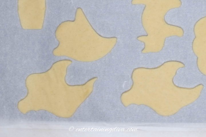 ghost cookie cutouts on cookie sheet