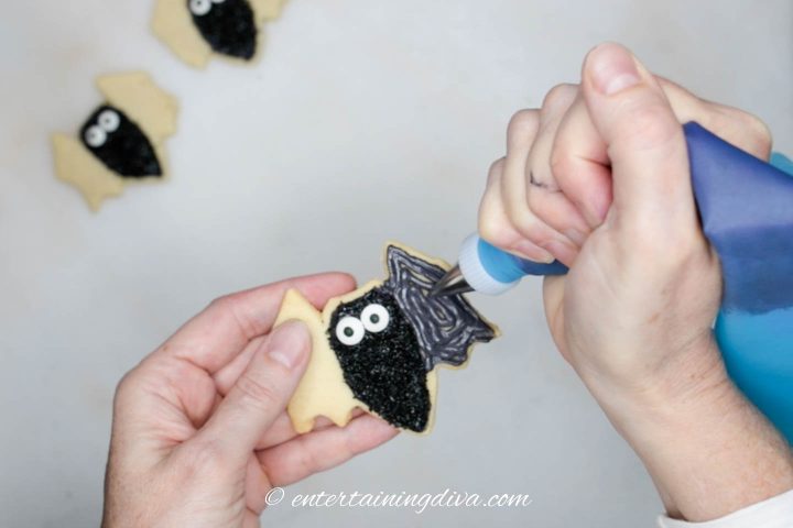 Bat wings being flooded with black royal icing