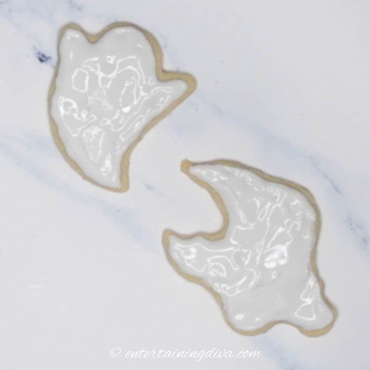 Royal icing flooded on ghost cookies