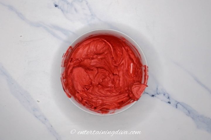 red buttercream icing in a bowl