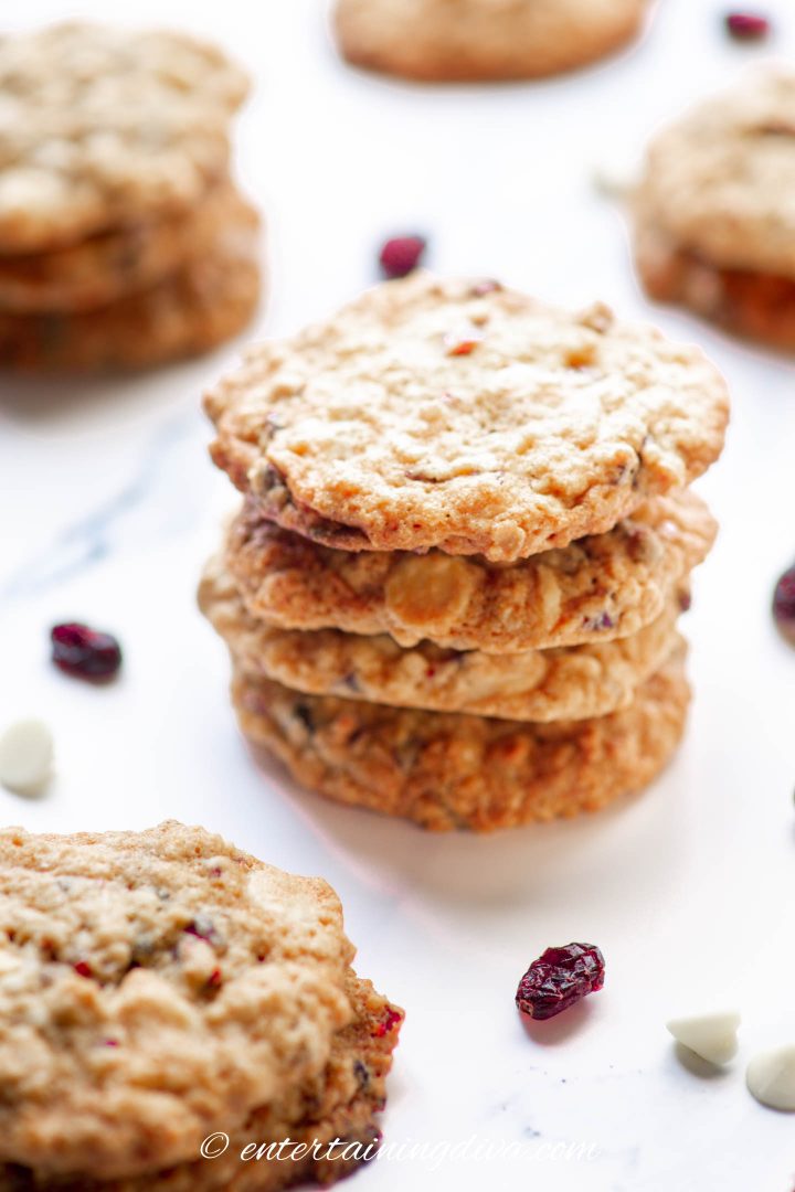 cranberry and white chocolate oatmeal cookies stacked on the counter