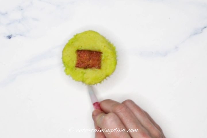 Marking the front of the cupcake with a pencil
