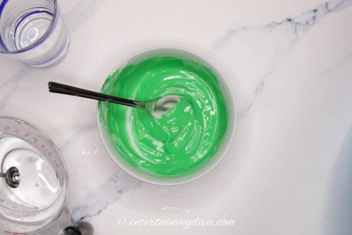 green royal icing in a bowl