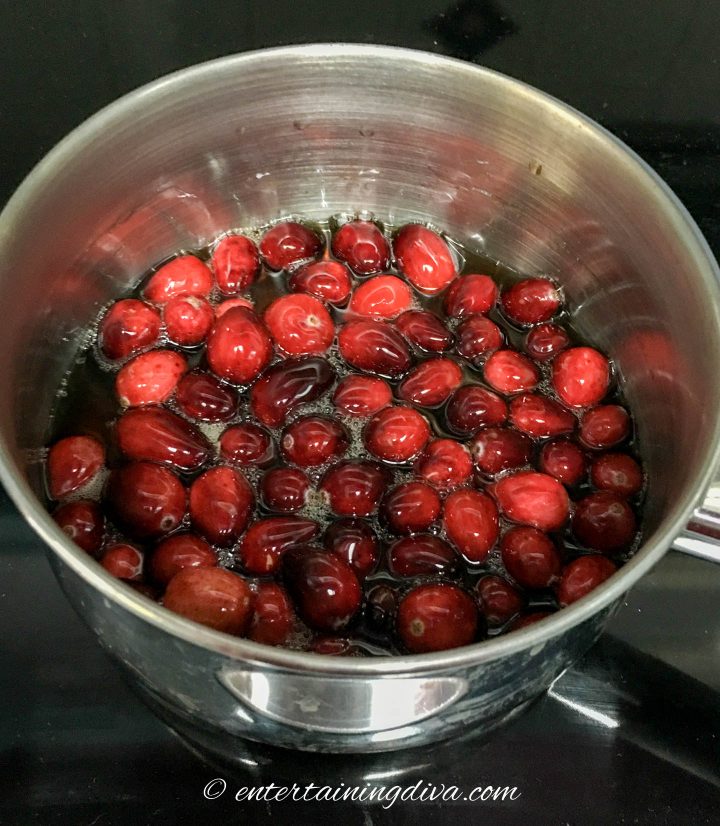 cranberries in maple syrup in a saucepan