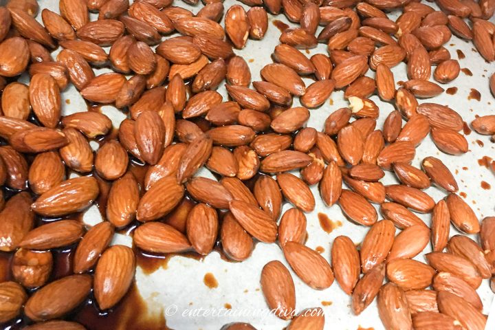 Almonds mixed with Tamari sauce on a cookie sheet
