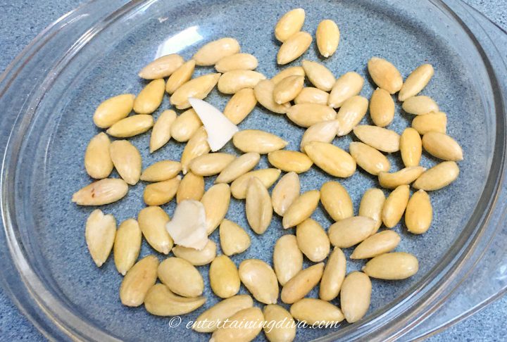 Blanched almonds and butter on a glass pie plate