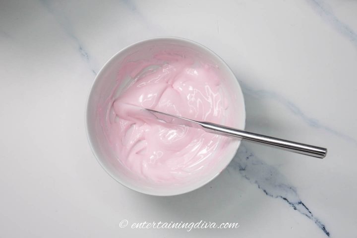 Light pink royal icing in a bowl