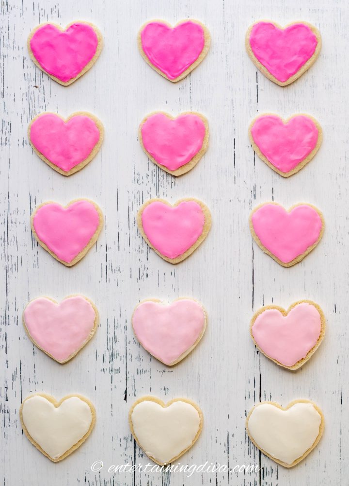heart cookies frosted with different shades of pink royal icing