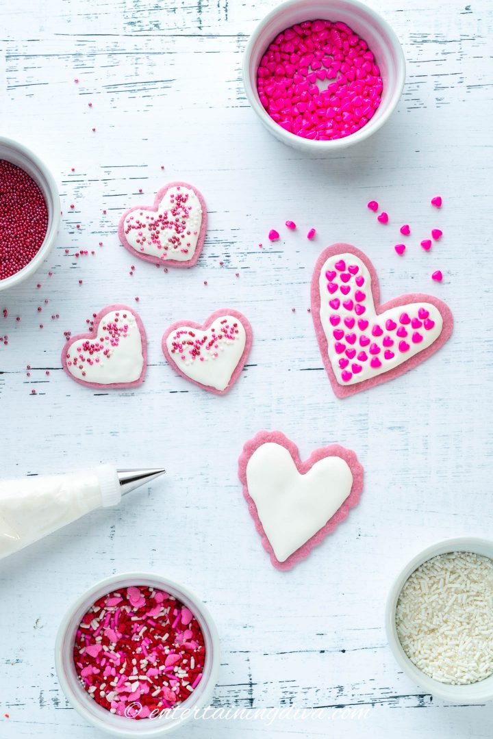 Valentine's Day Heart cookies with royal icing and various pink, red and white sprinkles
