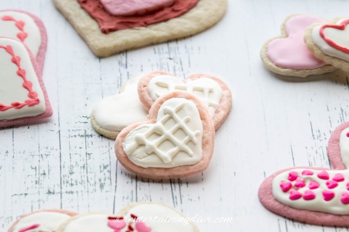 Heart cookies decorated with white royal icing and a criss-cross pattern