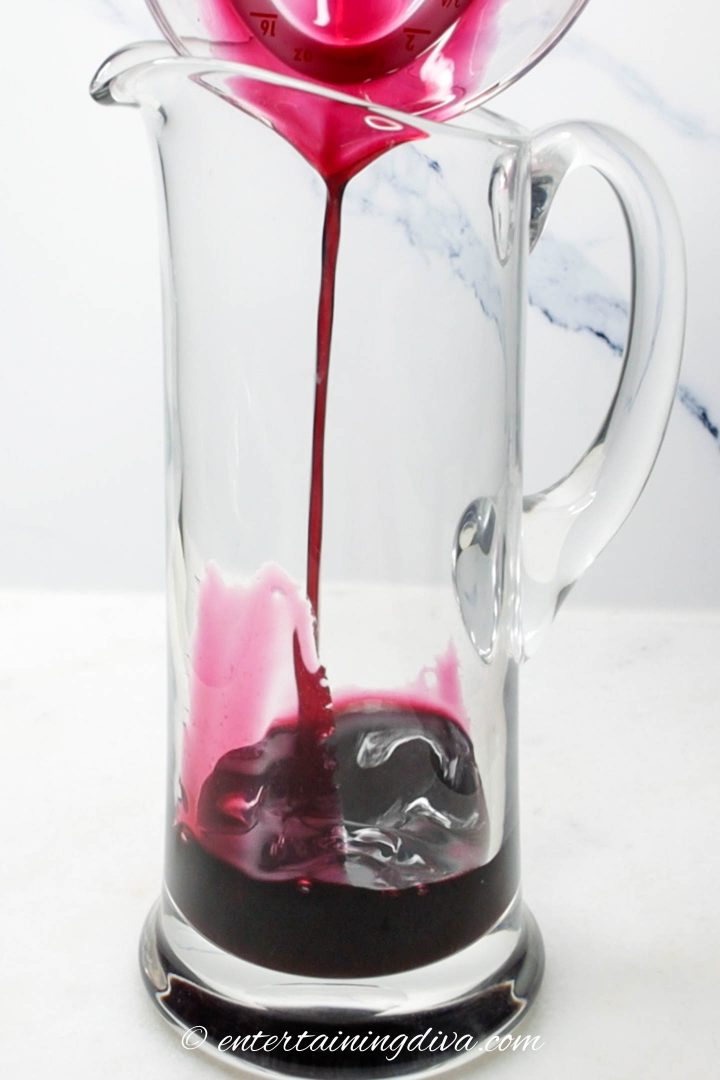 Blueberry syrup in glass pitcher