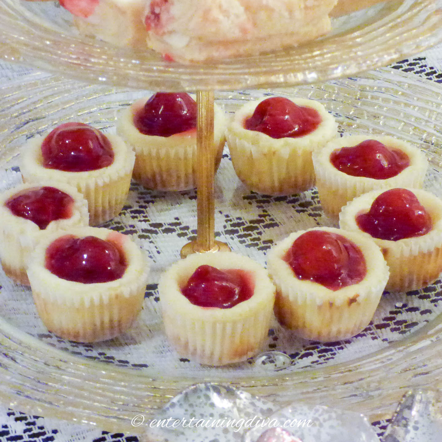 Mini cherry cheesecake cupcakes on a glass tray