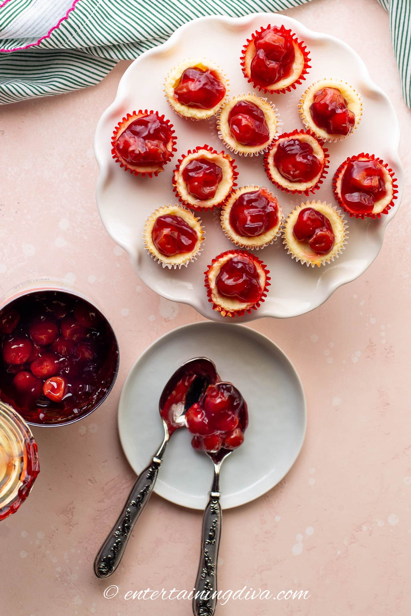 mini cherry cheesecake tarts with an open can of cherry pie filling