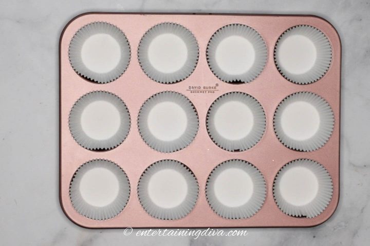 Muffin tin lined with cupcake liners