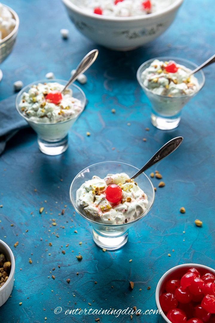 Watergate salad in glasses with cherries and spoons