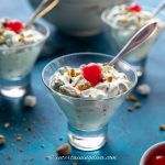 pistachio fruit salad with one cherry and spoon