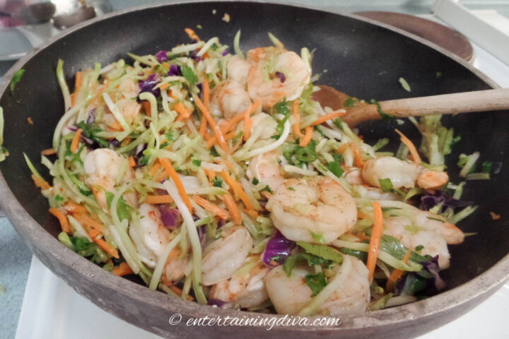 Shrimp taco mixture being tossed in a wok